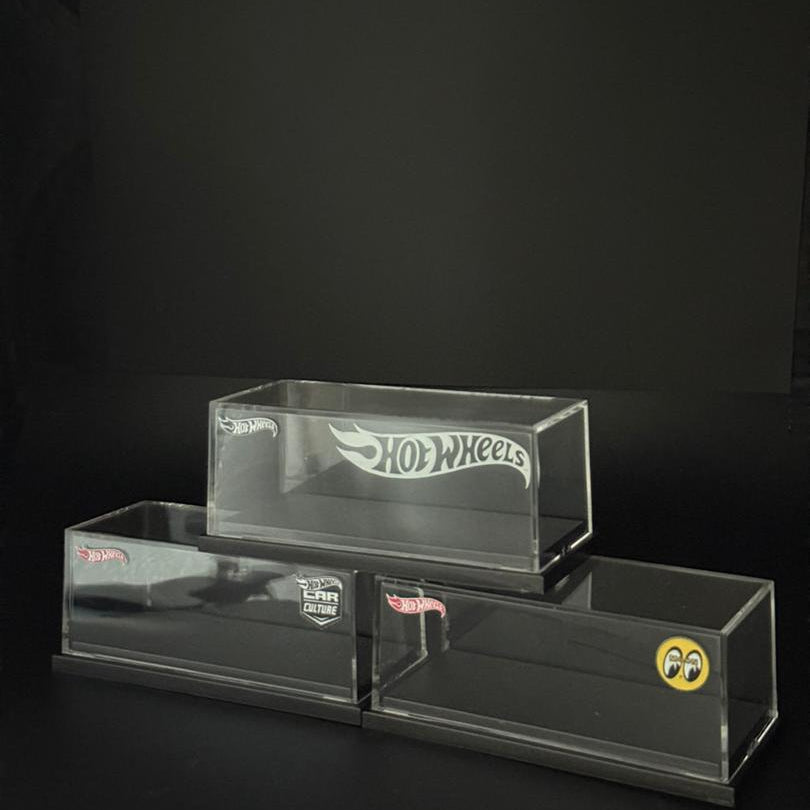 Clear display case with Hot Wheels logo on a black background